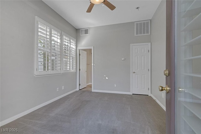 interior space with carpet flooring, visible vents, and baseboards