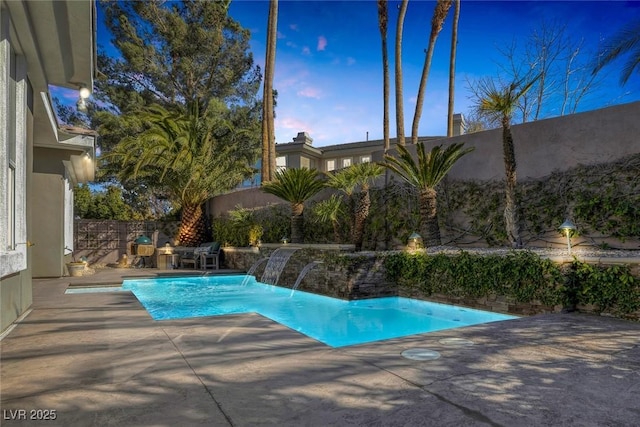 pool featuring a fenced backyard and a patio