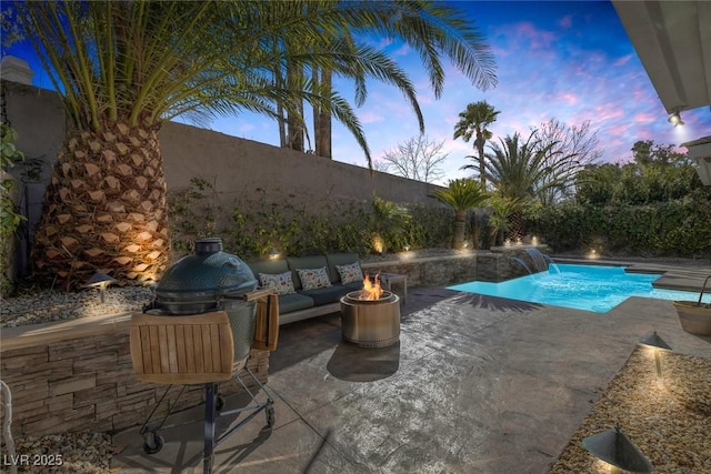 view of swimming pool featuring a fire pit, a patio, a fenced backyard, and a fenced in pool