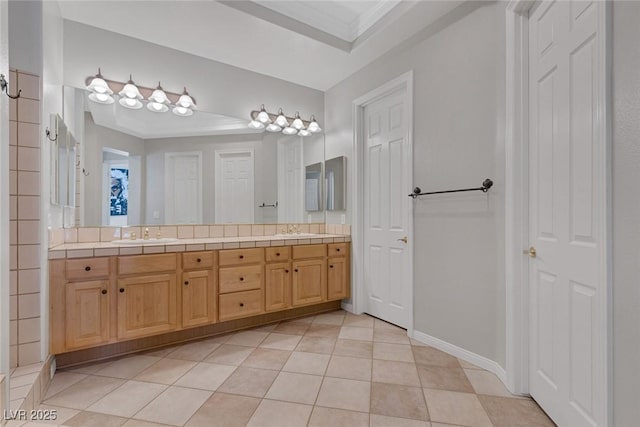 bathroom featuring tile patterned flooring, a sink, and double vanity