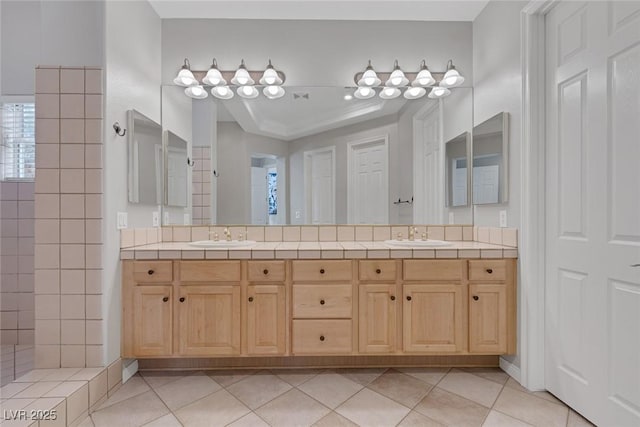 bathroom featuring double vanity, a sink, and tile patterned floors