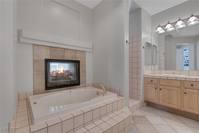 full bathroom featuring vanity, a bath, and tile patterned floors