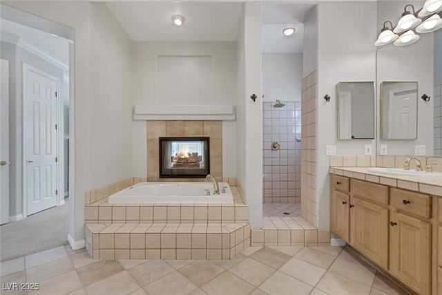 bathroom featuring a tile fireplace, tile patterned floors, walk in shower, vanity, and a bath