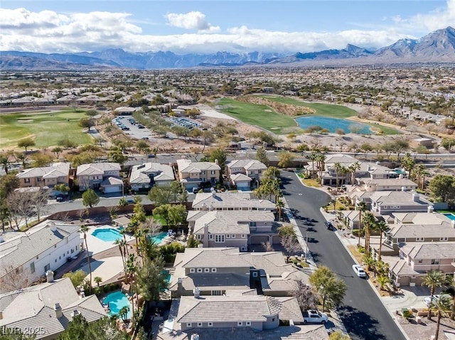 aerial view featuring view of golf course, a residential view, and a mountain view