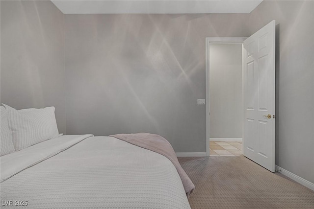 bedroom featuring light carpet and baseboards