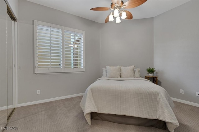 bedroom featuring a closet, baseboards, a ceiling fan, and light colored carpet