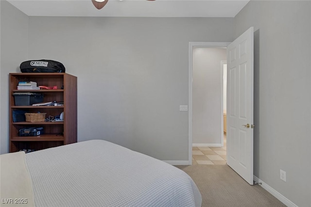 bedroom featuring light colored carpet and baseboards