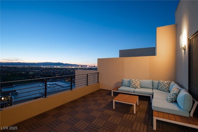 balcony featuring a mountain view and an outdoor hangout area