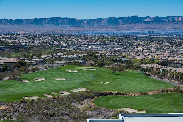 drone / aerial view with a residential view, a mountain view, and golf course view