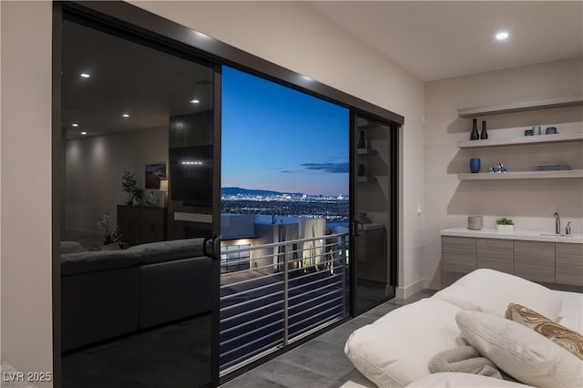 bedroom with baseboards, a sink, and recessed lighting