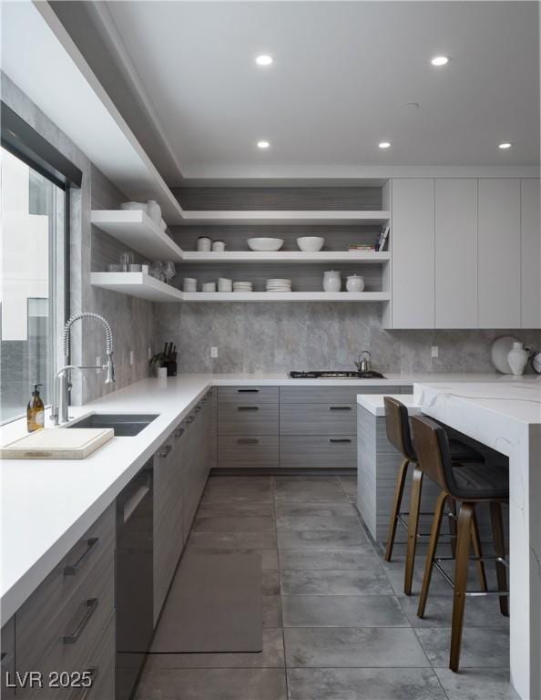 kitchen featuring open shelves, tasteful backsplash, a sink, modern cabinets, and dishwasher