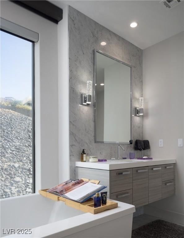 bathroom with recessed lighting, visible vents, and vanity