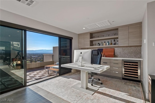 office space featuring wine cooler, visible vents, a mountain view, and recessed lighting