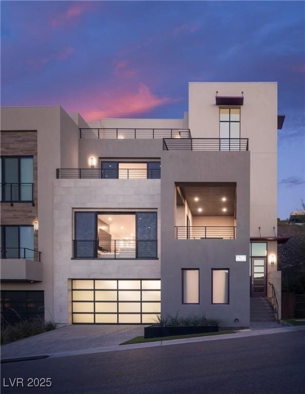 modern home with a balcony and stucco siding