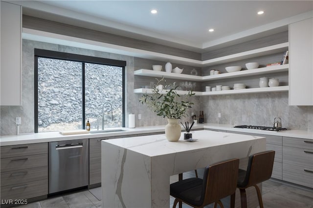 kitchen with a kitchen island, a breakfast bar area, gas stovetop, open shelves, and stainless steel dishwasher