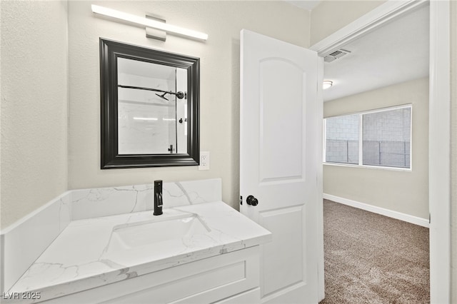 full bath featuring a shower, vanity, and baseboards