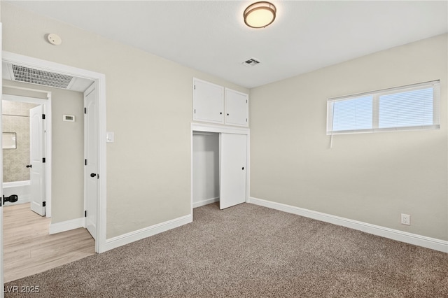 unfurnished bedroom with light colored carpet, visible vents, and baseboards