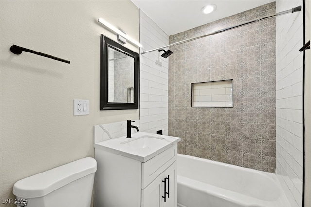 full bathroom featuring shower / bath combination, a textured wall, vanity, and toilet