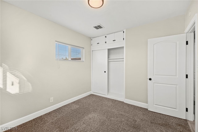 unfurnished bedroom with carpet floors, a closet, visible vents, and baseboards