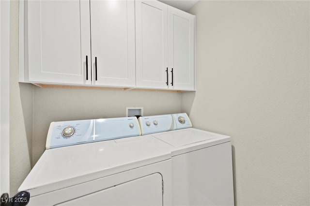 laundry room featuring washer and clothes dryer and cabinet space