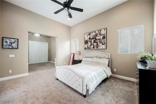 bedroom with light carpet, ceiling fan, and baseboards