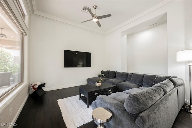 living room with dark wood-type flooring, crown molding, baseboards, and ceiling fan