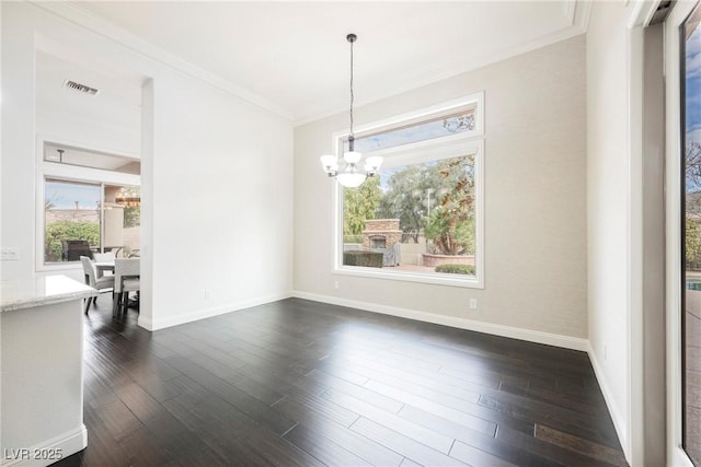 unfurnished dining area with visible vents, dark wood finished floors, a notable chandelier, and ornamental molding