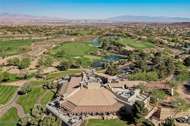 drone / aerial view featuring golf course view and a water and mountain view