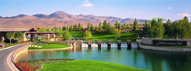 view of community with a water and mountain view