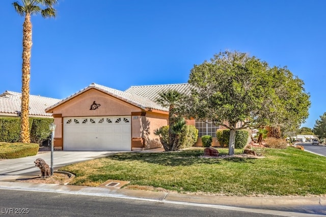 view of front facade featuring a tiled roof, a front lawn, an attached garage, and stucco siding