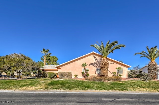 view of property exterior with a lawn and stucco siding