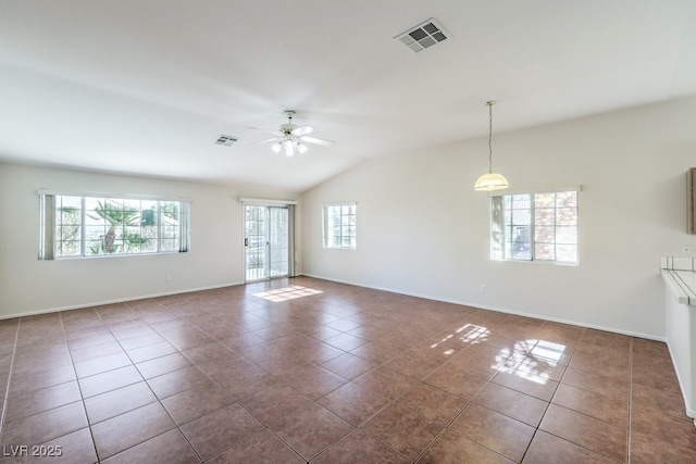 unfurnished room featuring dark tile patterned floors and visible vents