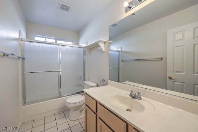 full bathroom with visible vents, bath / shower combo with glass door, toilet, tile patterned flooring, and vanity