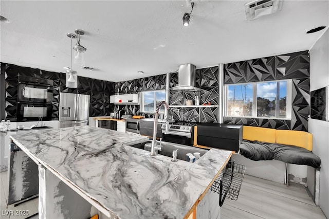 kitchen featuring visible vents, a kitchen island, and stainless steel fridge with ice dispenser