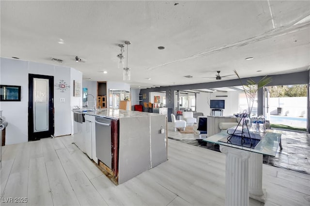 kitchen with open floor plan, hanging light fixtures, a large island, and plenty of natural light