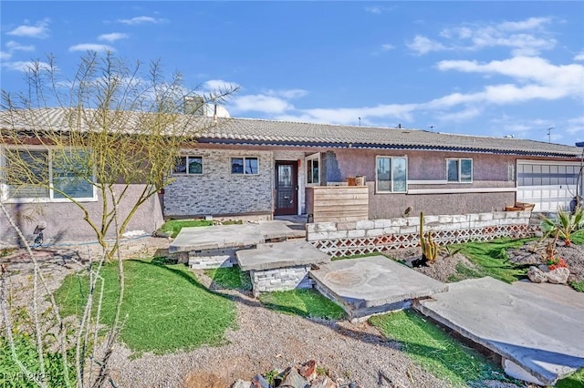 view of front of property featuring a tiled roof and stucco siding