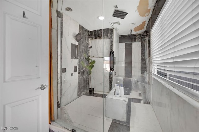 bathroom with a marble finish shower