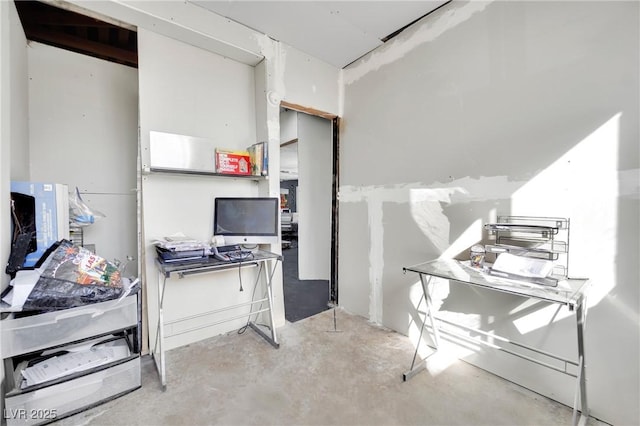 office area with unfinished concrete floors