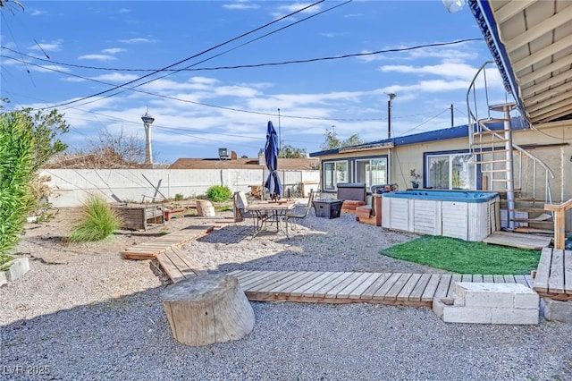 view of yard featuring a patio area, a fenced backyard, a vegetable garden, and a hot tub