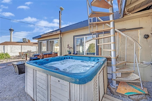 exterior space with fence and a hot tub