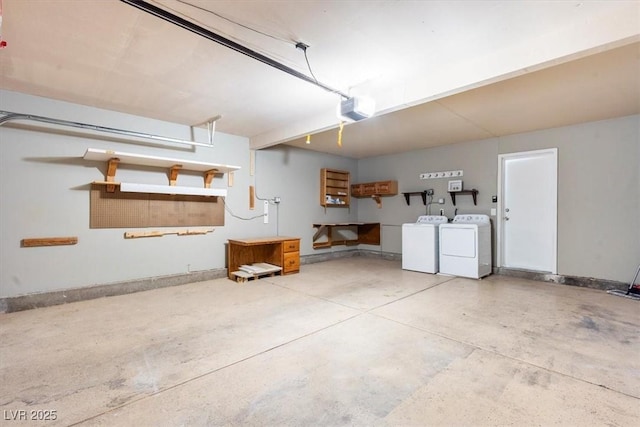 garage with a garage door opener, independent washer and dryer, and baseboards