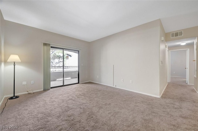 empty room featuring light carpet, visible vents, and baseboards