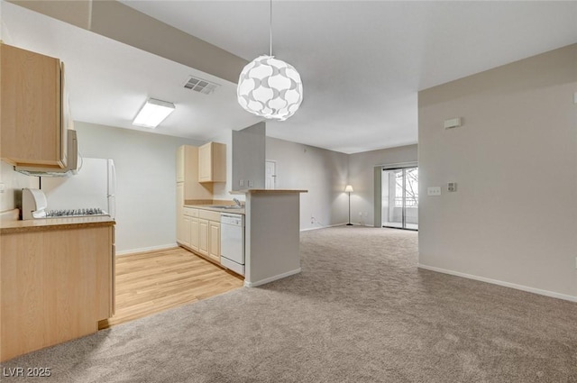 kitchen with light colored carpet, white appliances, visible vents, open floor plan, and pendant lighting