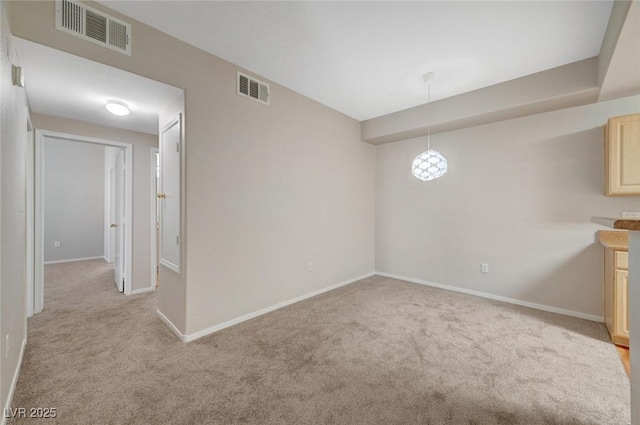 unfurnished room featuring light carpet, visible vents, and baseboards