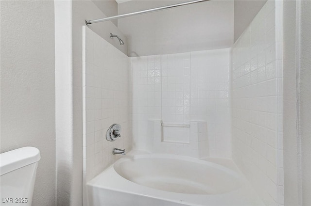 bathroom with toilet and shower / bathing tub combination