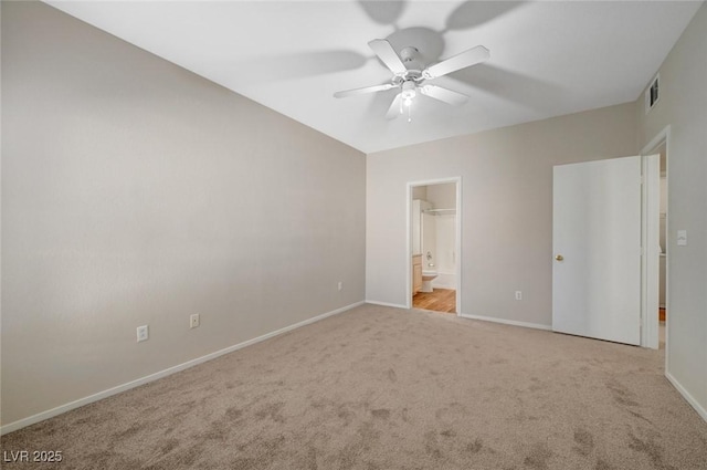 unfurnished bedroom with ceiling fan, light carpet, visible vents, baseboards, and ensuite bath