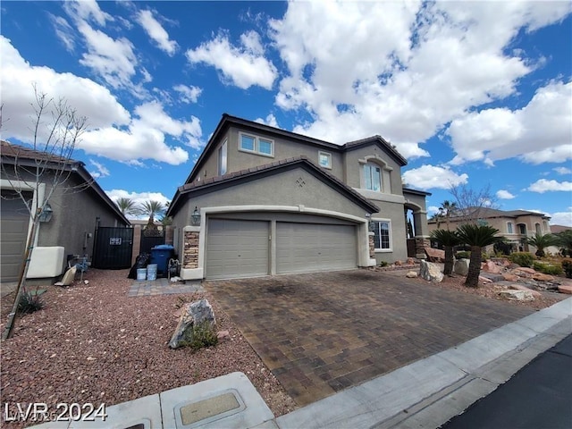 view of front of property featuring decorative driveway and stucco siding