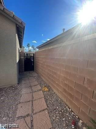 view of home's exterior with a gate