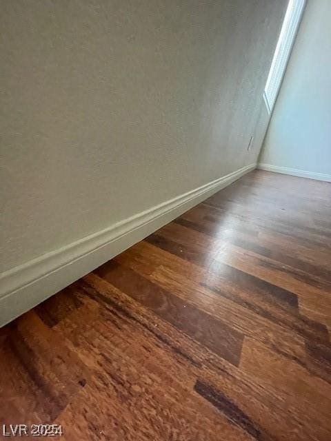 details with baseboards and wood finished floors