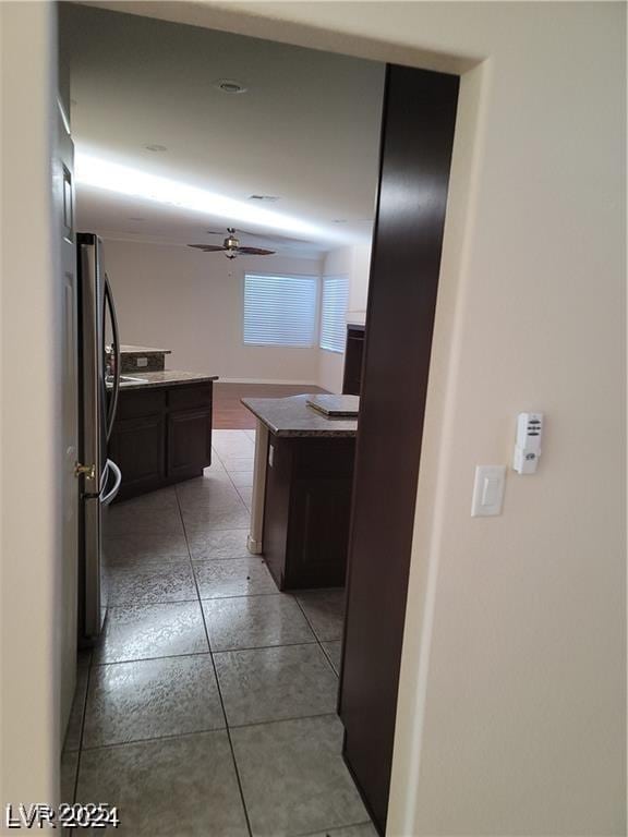 hall featuring light tile patterned flooring